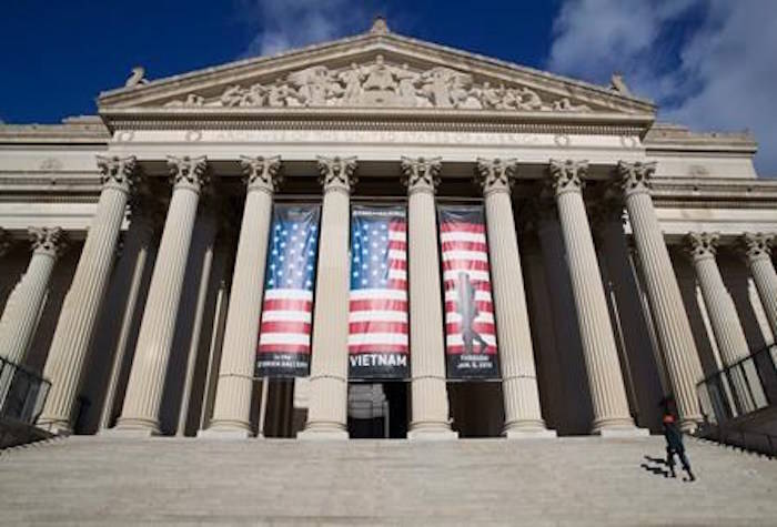 People walk up the steps even though the National Archives is closed with the partial government shutdown, Saturday, Dec. 22, 2018 in Washington. (AP Photo/Alex Brandon)