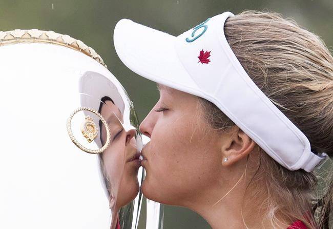 Golfer Brooke Henderson of Smiths Falls, Ont., kisses the trophy after winning the CP Women’s Open in Regina, Sunday, Aug. 26, 2018. (THE CANADIAN PRESS/Jonathan Hayward)
