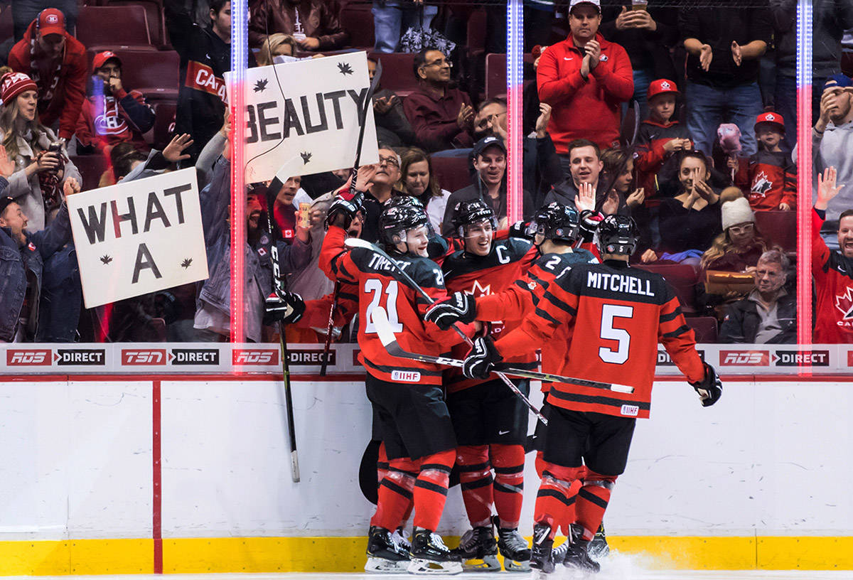 Canada’s Owen Tippett, from left to right, Maxime Comtois, Evan Bouchard and Ian Mitchell celebrate Comtois’ goal against Denmark during second period IIHF world junior hockey championship action in Vancouver, on Wednesday December 26, 2018. (Darryl Dyck/The Canadian Press)
