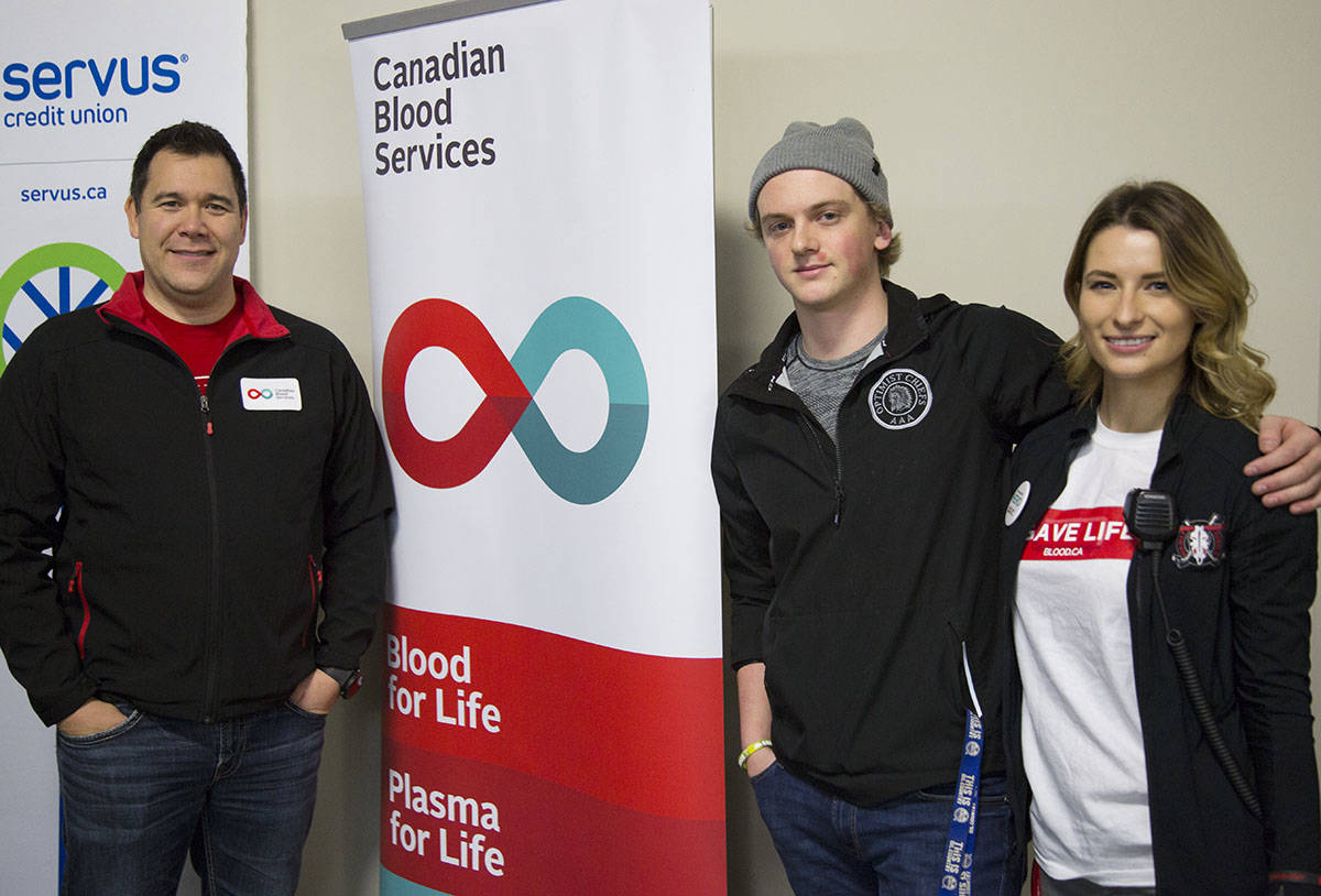 Shaun Richer with Red Deer’s Canadian Blood Services, left, former Humboldt Broncos Graysen Cameron and Marissa Stryker, also with Canadian Blood Services, pose for a photo at the kickoff of the annual blood donor challenge between the Red Deer Rebels and Lethbridge Hurricanes Wednesday at the Centrium. The challenge runs through January. Robin Grant/Red Deer Express