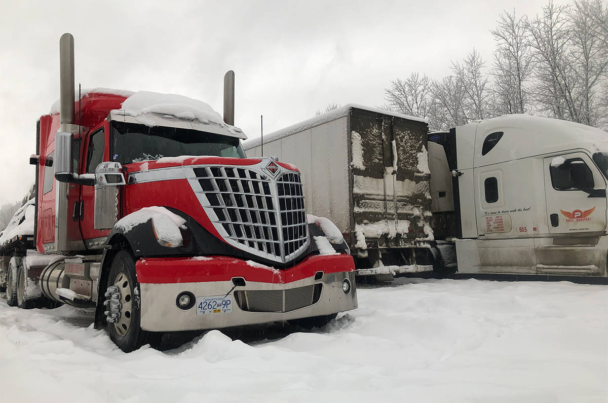 Semi trucks put on chains and wait for road conditions to improve in Revelstoke. Highway 1 is closed near Golden until 8 p.m. for avalanche control. (Liam Harrap/Revelstoke Review)