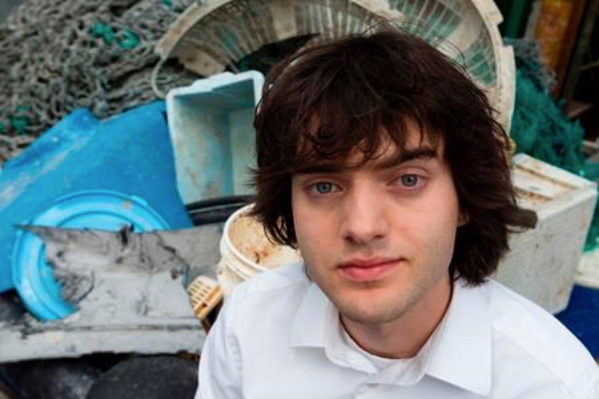 FILE - In this May 11, 2017, file photo, Dutch innovator Boyan Slat poses for a portrait next to a pile of plastic garbage prior to a press conference in Utrecht, Netherlands. (AP Photo/Peter Dejong, File)