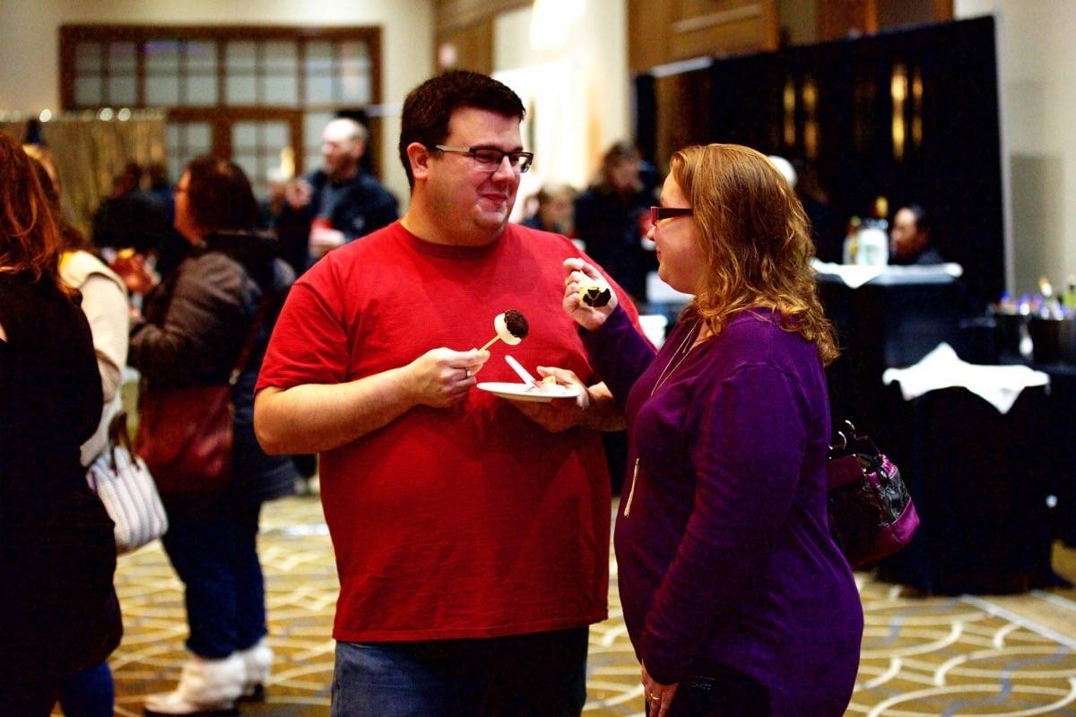 Randy Butler, left, and Jenn Key sample the wedding desserts at the show Sunday. Robin Grant/Red Deer Express