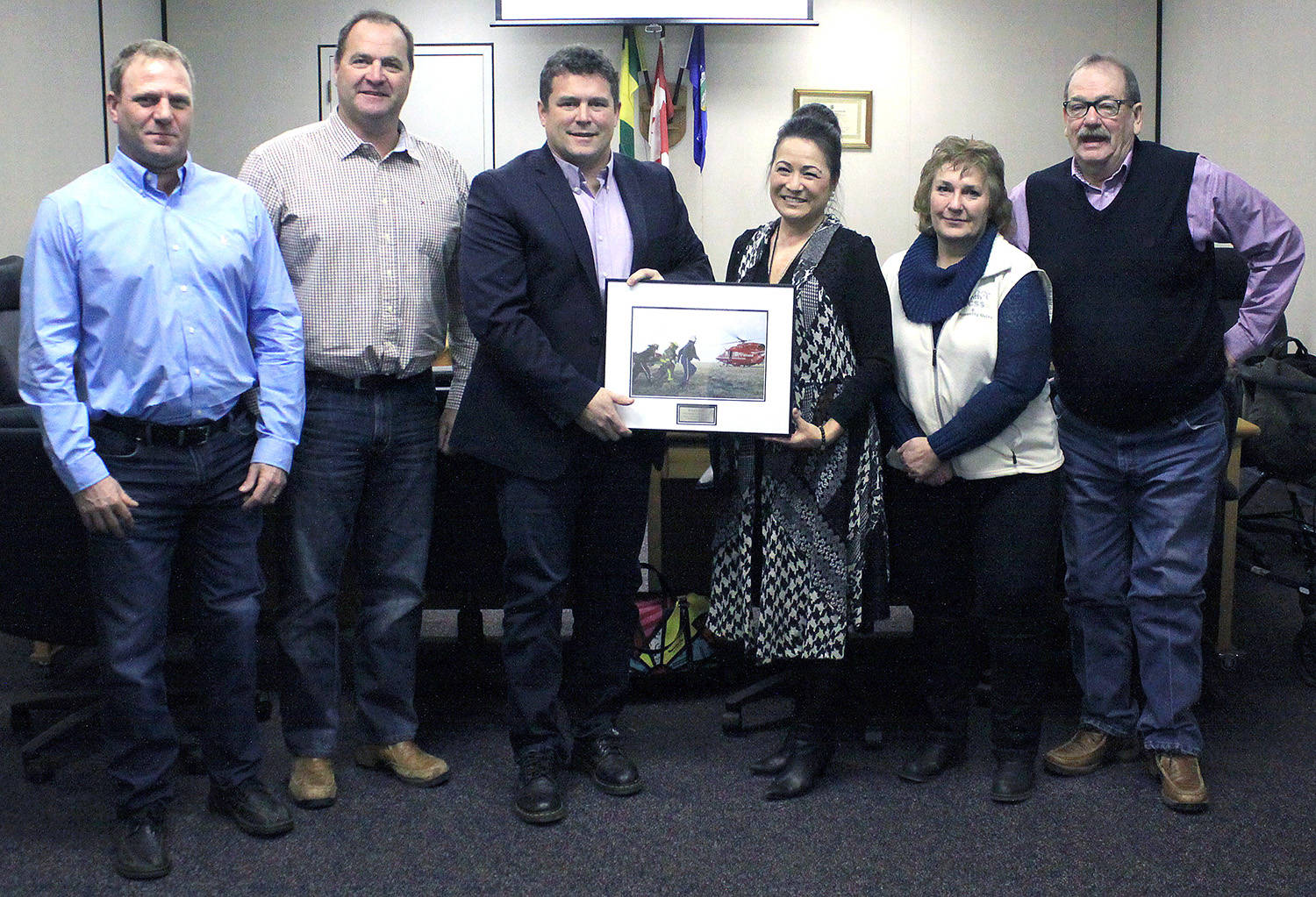 Ponoka County Reeve Paul McLauchlin, surrounded by the rest of council, accepts a token of appreciation from STARS senior municipal relations liaison Glenda Farnden for the county’s continued contributions to the success of the air ambulance service that’s been in operation since 1985. Photo by Jordie Dwyer