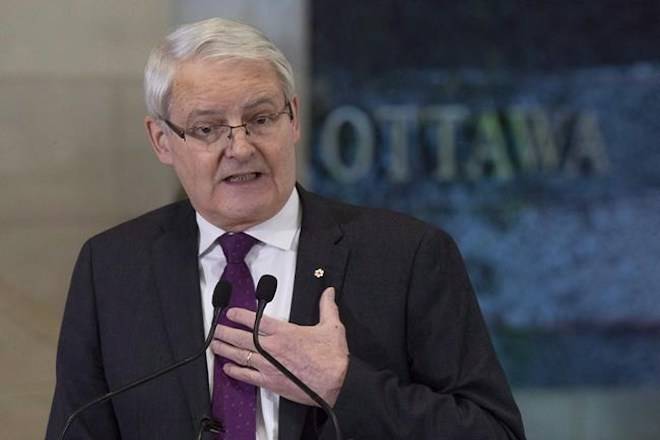 Transport Minister Marc Garneau speaks about passenger rights during a news conference at the airport in Ottawa, Monday December 17, 2018. Anyone flying a drone in Canada will have to pass an online exam and get a pilot’s certificate under new rules to be announced today by Garneau. THE CANADIAN PRESS/Adrian Wyld