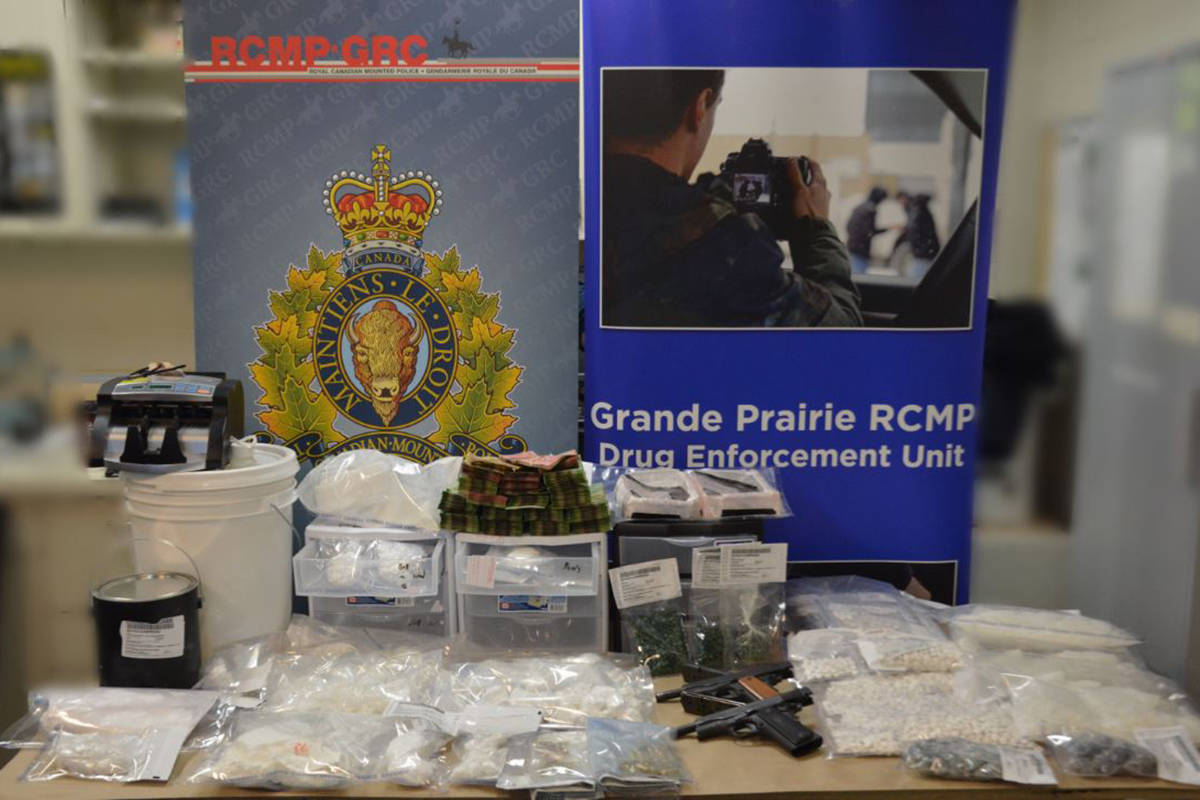 Grande Prairie RCMP seized $600,000 worth of illegal drugs in a search warrant on Jan. 8. This image, with the background blurred out, shows the drugs, cash and hand guns that were seized. RCMP photo