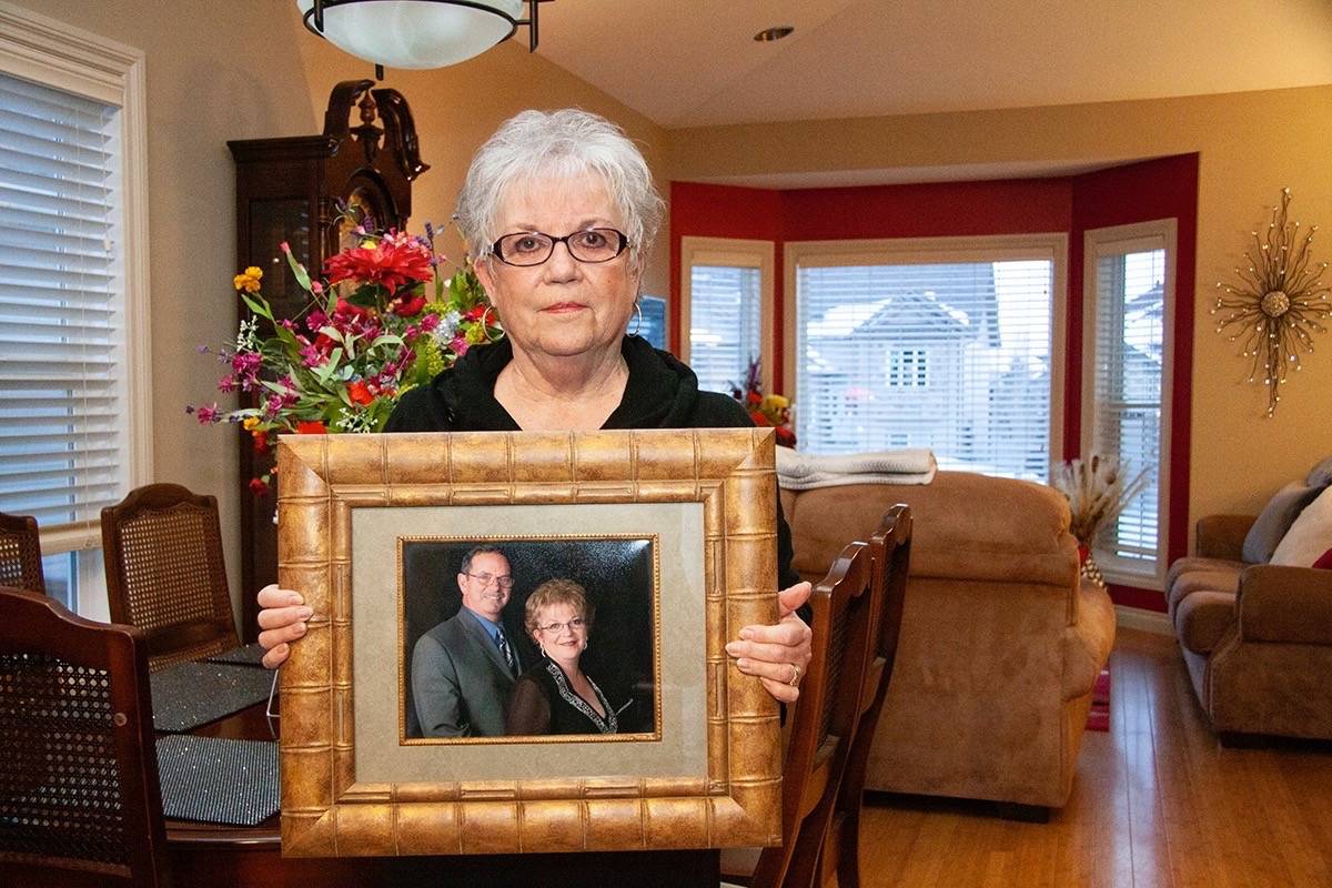 Lacombe resident Linda Tomlinson holds a portrait of herself with husband Wendell, who passed away from dementia last May. This month marks Alzheimer Awareness Month.                                Todd Colin Vaughn/Red Deer Express