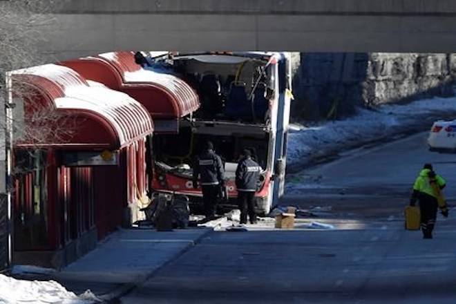 Transport Canada officials look at the scene where a double-decker city bus struck a transit shelter at the start of the afternoon rush hour on Friday, at Westboro Station in Ottawa, on Saturday, Jan. 12, 2019. THE CANADIAN PRESS/Justin Tang