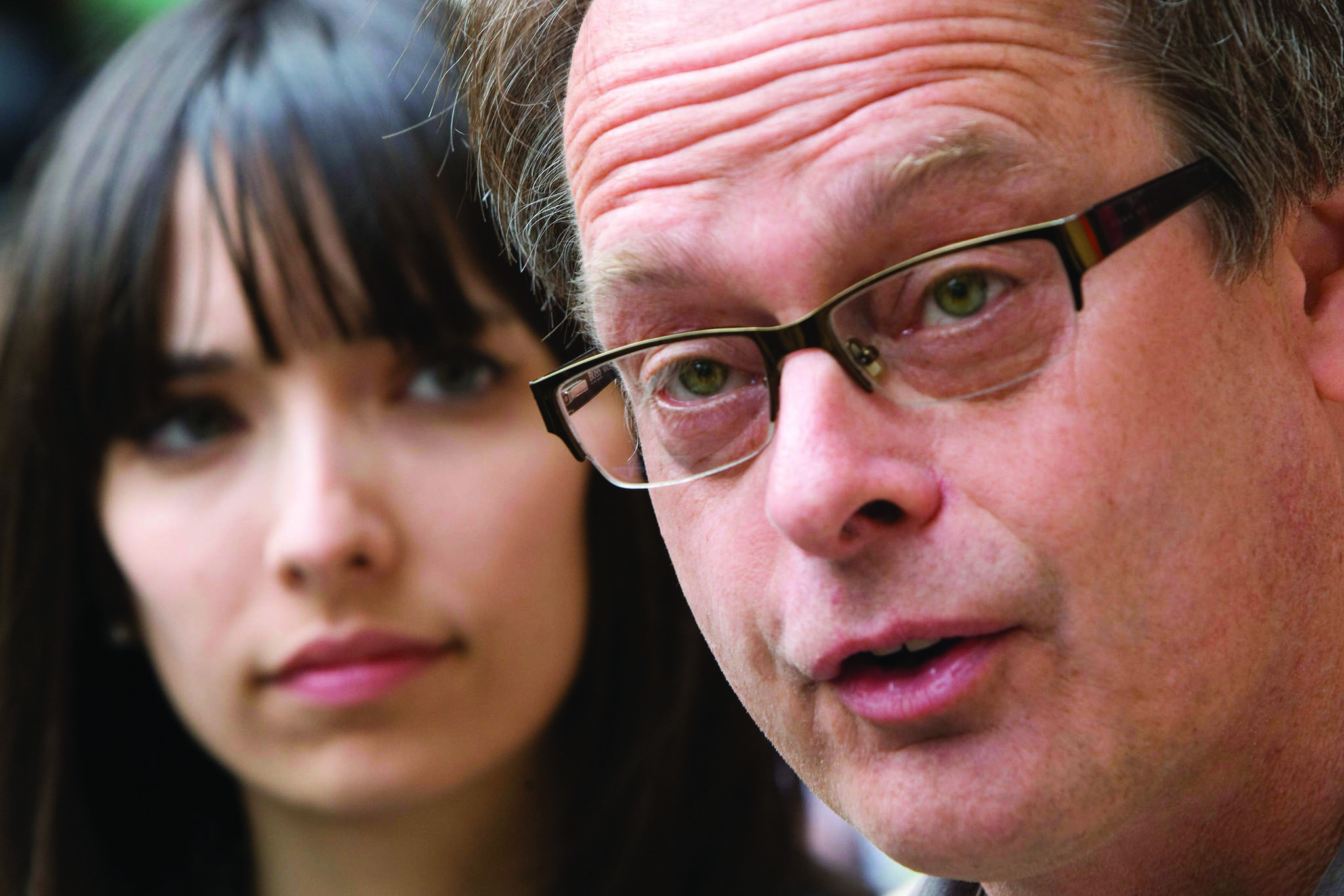 FILE - In this May 10, 2010 file photo, Marc Emery, the self-described “Prince of Pot” speaks to reporters outside the Supreme Court in Vancouver, British Columbia Monday, prior to turning himself in to be extradited to the United States as his wife Jodie, left, looks on. Emery and his wife have been arrested in Toronto on Wednesday, March 8, 2017 and police are raiding several of his marijuana dispensaries, his lawyer said. (AP Photo/The Canadian Press, Jonathan Hayward, File)