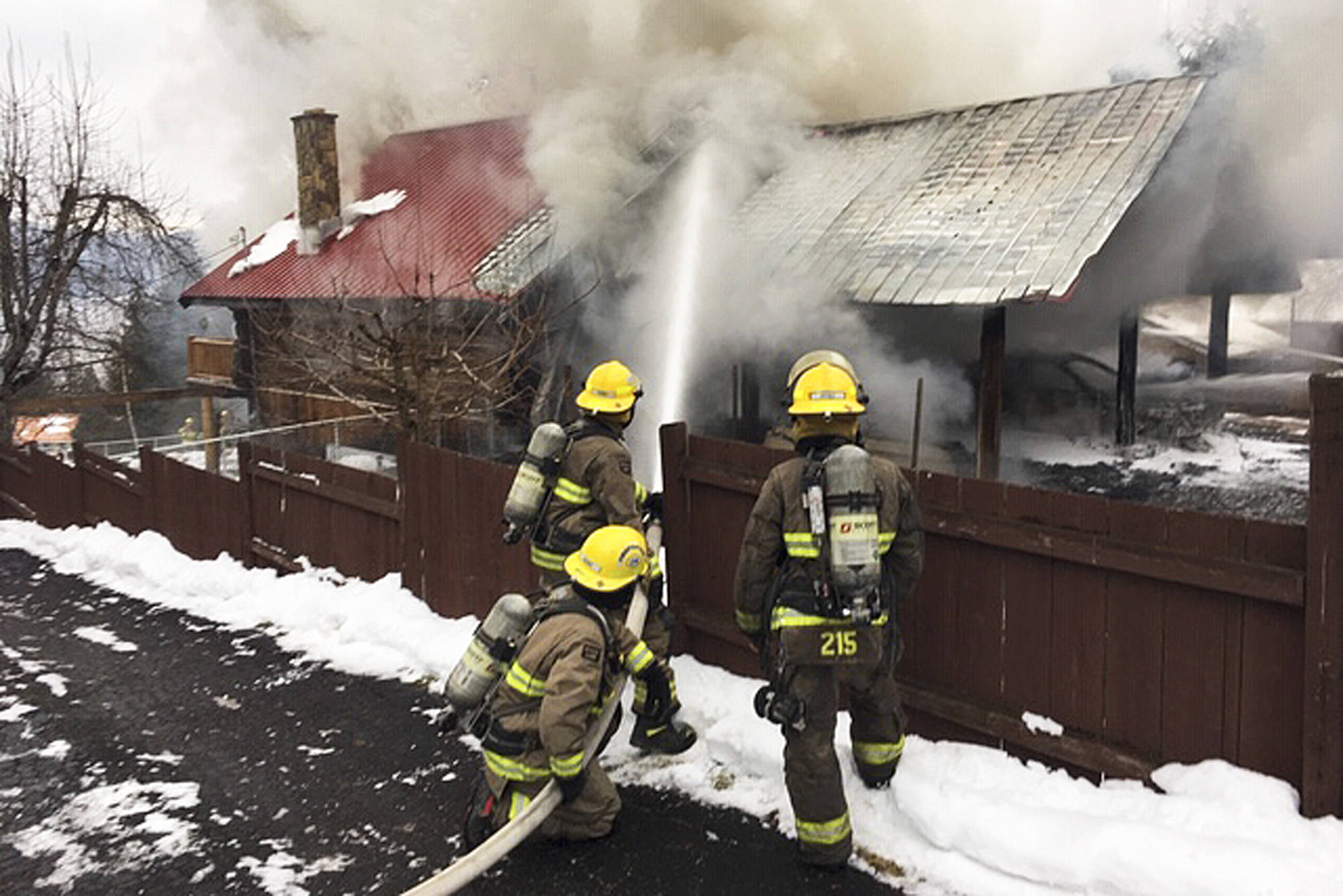 Columbia Shuswap Regional District firefighters attack a blaze in a home on Centennial Road in Blind Bay on Monday, Jan. 14.                                (Sean Coubrough photo)