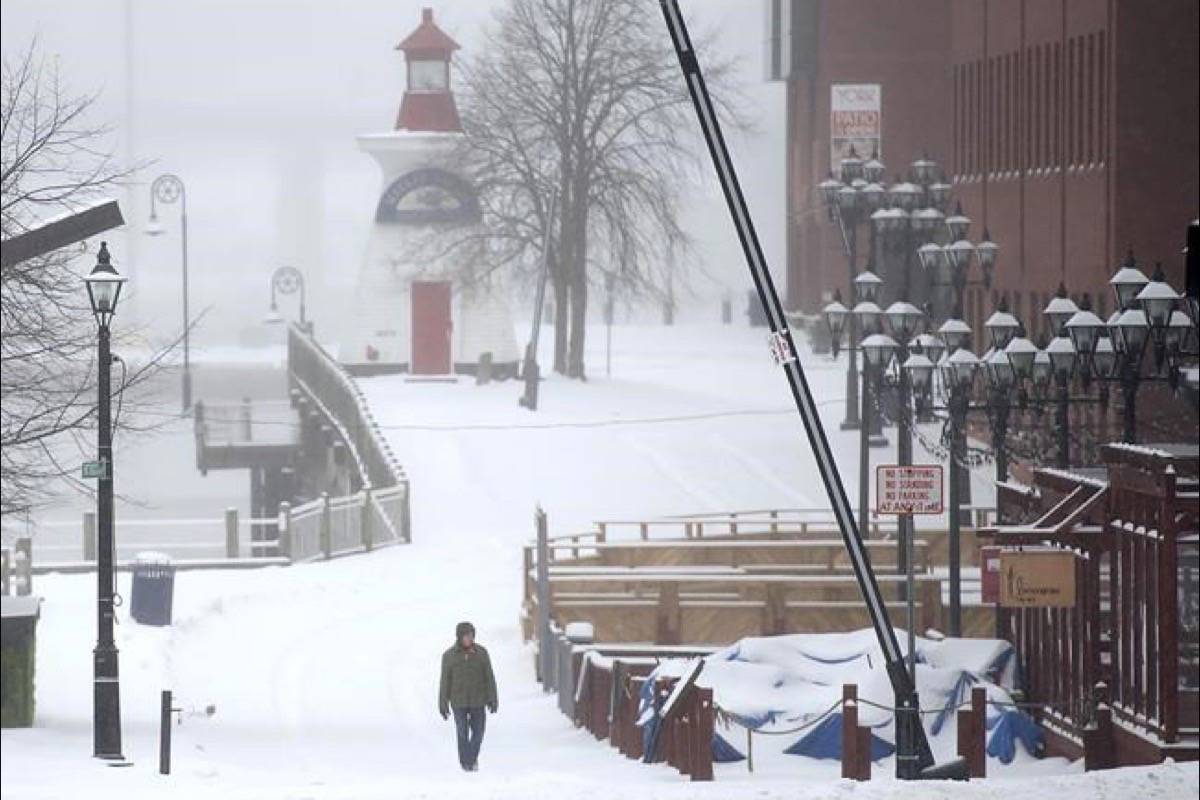 A pedestrian braves the elements at the start of a major winter storm in Saint John, N.B. on Sunday, Jan. 20, 2019. Environment Canada has issued a winter storm warning for the maritime provinces with snow, rain and freeing rain expected. (Andrew Vaughan/The Canadian Press)