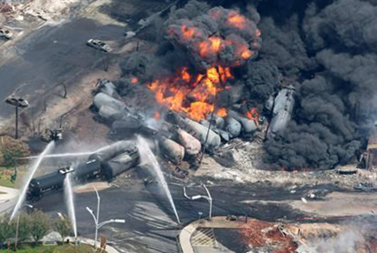 Smoke rises from railway cars that were carrying crude oil after derailing in downtown Lac-Magantic, Que., Saturday, July 6, 2013. (Paul Chiasson/The Canadian Press)