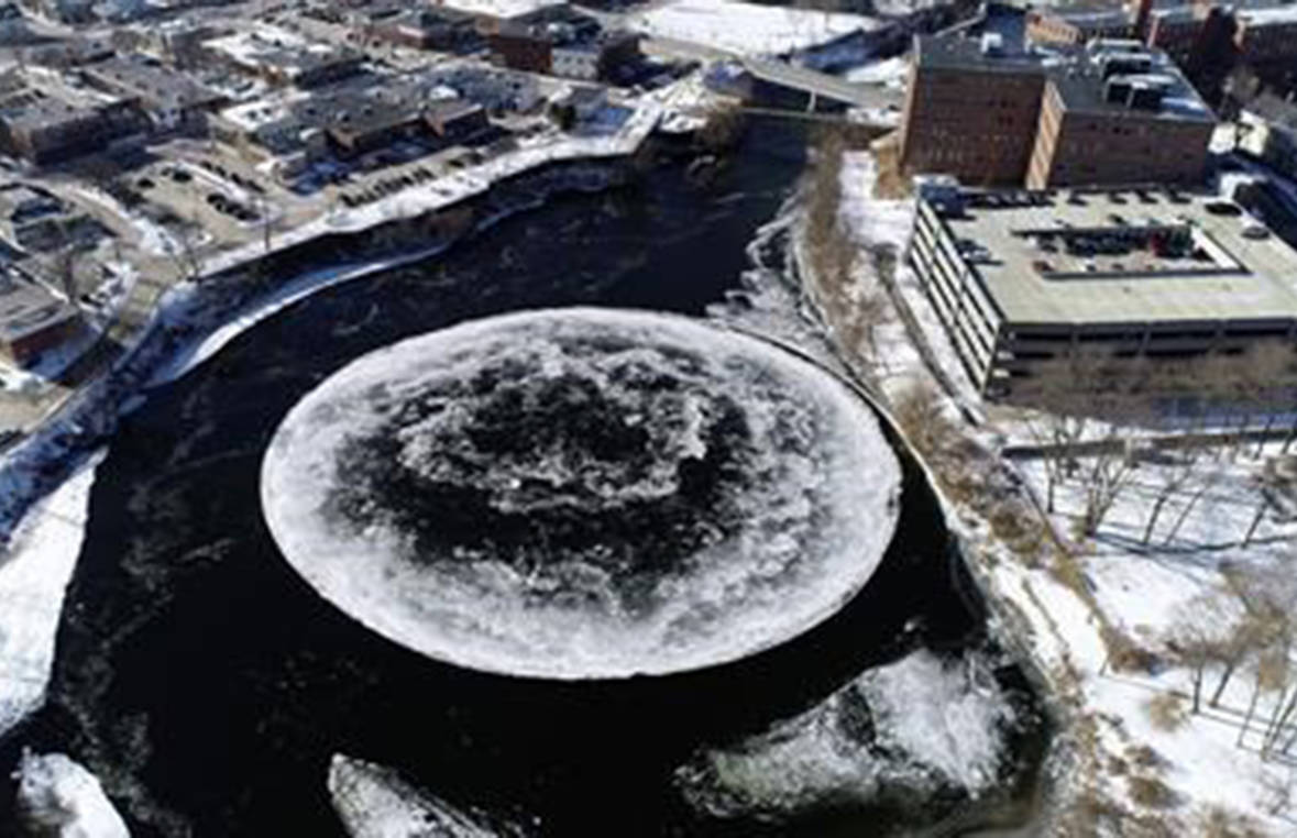 FILE - In this Monday, Jan. 14, 2019 aerial file image taken from a drone video and provided by the City of Westbrook, Maine, a naturally occurring ice disk forms on the Presumpscot River in Westbrook, Maine. The giant spinning ice disk, that quickly gained international fame and grew larger over the weekend, now has its own webcam. (Tina Radel/City of Westbrook via AP, File)