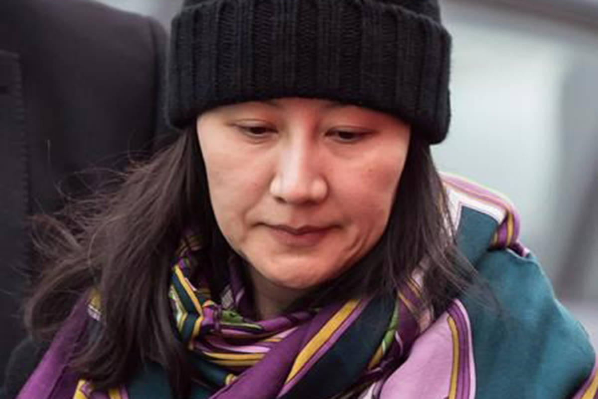 Huawei chief financial officer Meng Wanzhou is escorted by her private security detail while arriving at a parole office, in Vancouver, on Wednesday December 12, 2018.