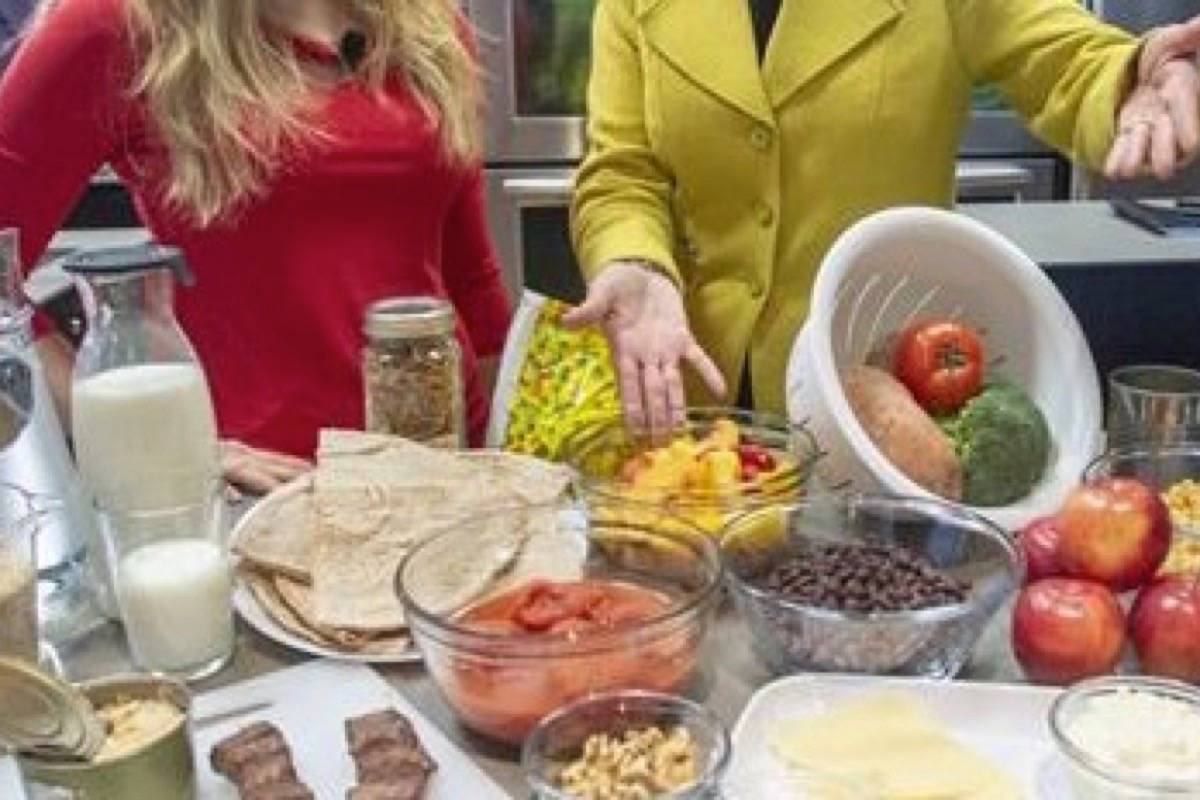 Health Minister Ginette Petitpas Taylor, right, and nutritionist Jessica Cole look over samples of some of the food groups at the unveiling of Canada’s new Food Guide, Tuesday, January 22, 2019 in Montreal. (THE CANADIAN PRESS/Ryan Remiorz)