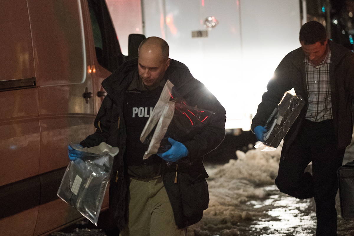Police officers carry evidence after raiding a house in Kingston, Ontario, on Thursday Jan. 24, 2019. THE CANADIAN PRESS/Lars Hagberg