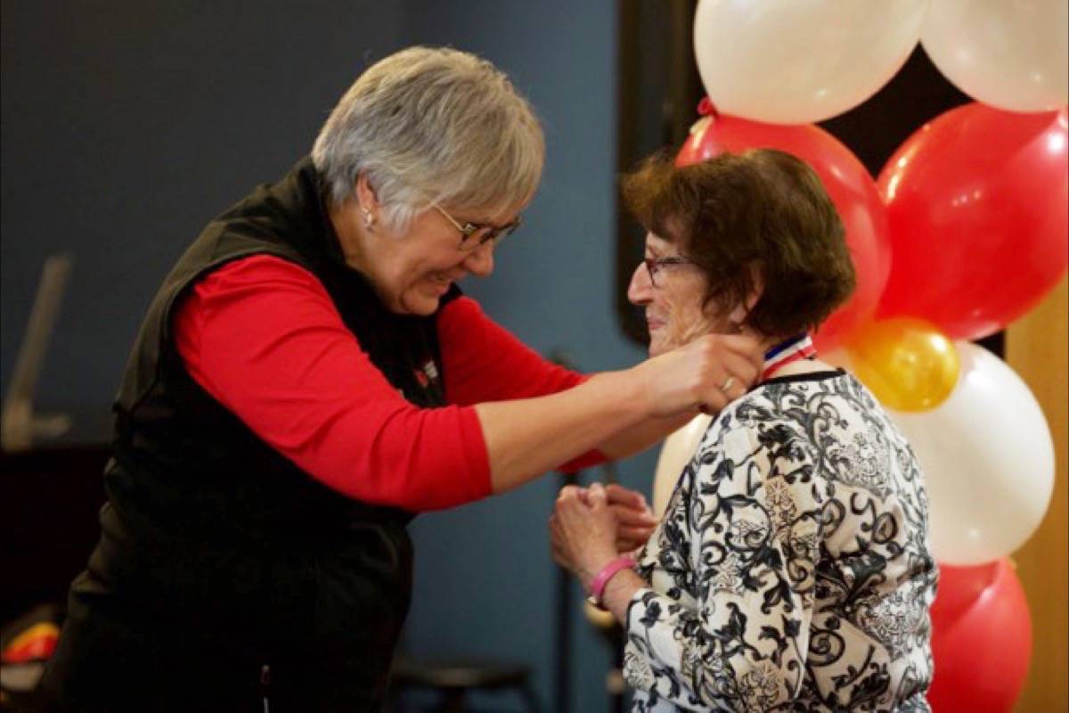 Board Chair of the Canada Winter Games Committee Lyn Radford presents CollegeSide Gardens resident Madeleine Hodgen with her medal at a presentation ceremony Friday morning. Residents took part in the 2019 Bethany CollegeSide Resident Winter Games from Jan. 15th to 24th. Robin Grant/Red Deer Express
