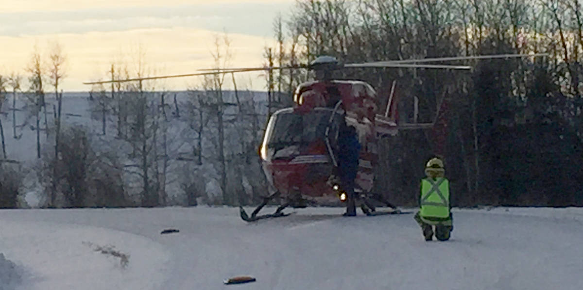 A Ponoka County East District firefighter guides STARS Air Ambulance to the scene of the rock hauler in the river. The driver was trapped in the truck and received minor injuries but was not needed to be transported to Edmonton. He was released that same evening. Photo submitted