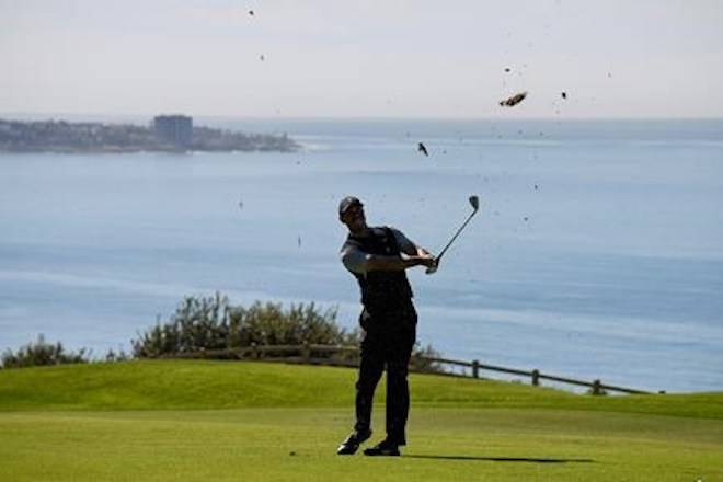 Tiger Woods hits his second shot on the 16th hole during the second round of the Farmers Insurance Open golf tournament on the North Course at the Torrey Pines on Friday, Jan. 25, 2019, in San Diego. (AP Photo/Denis Poroy)