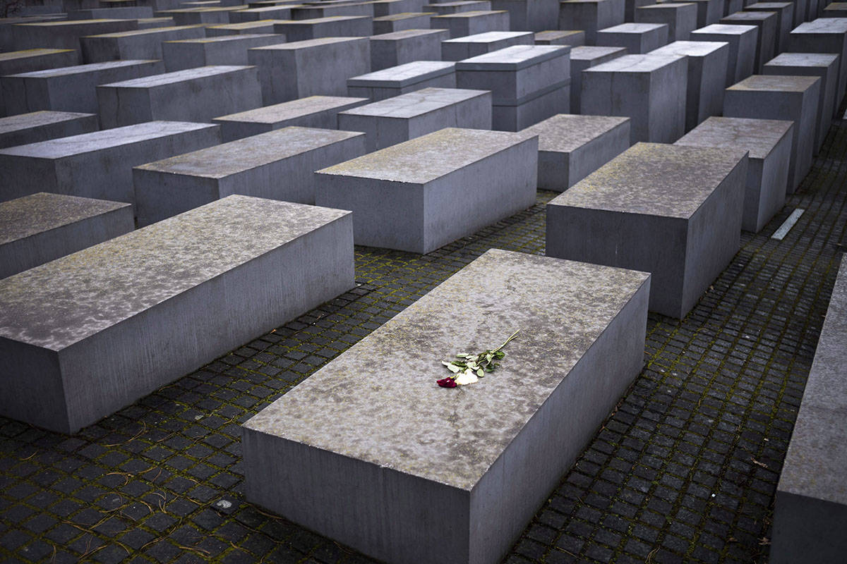 Flowers lay on a slab of the Holocaust Memorial to commemorate the victims of the Nazi at the Holocaust Memorial in Berlin, Germany, Wednesday, Jan. 31, 2018. Following the International Holocaust Remembrance Day on Jan. 27, the German parliament Bundestag meets for a special session today to commemorate the Holocaust victims. (AP Photo/Markus Schreiber)