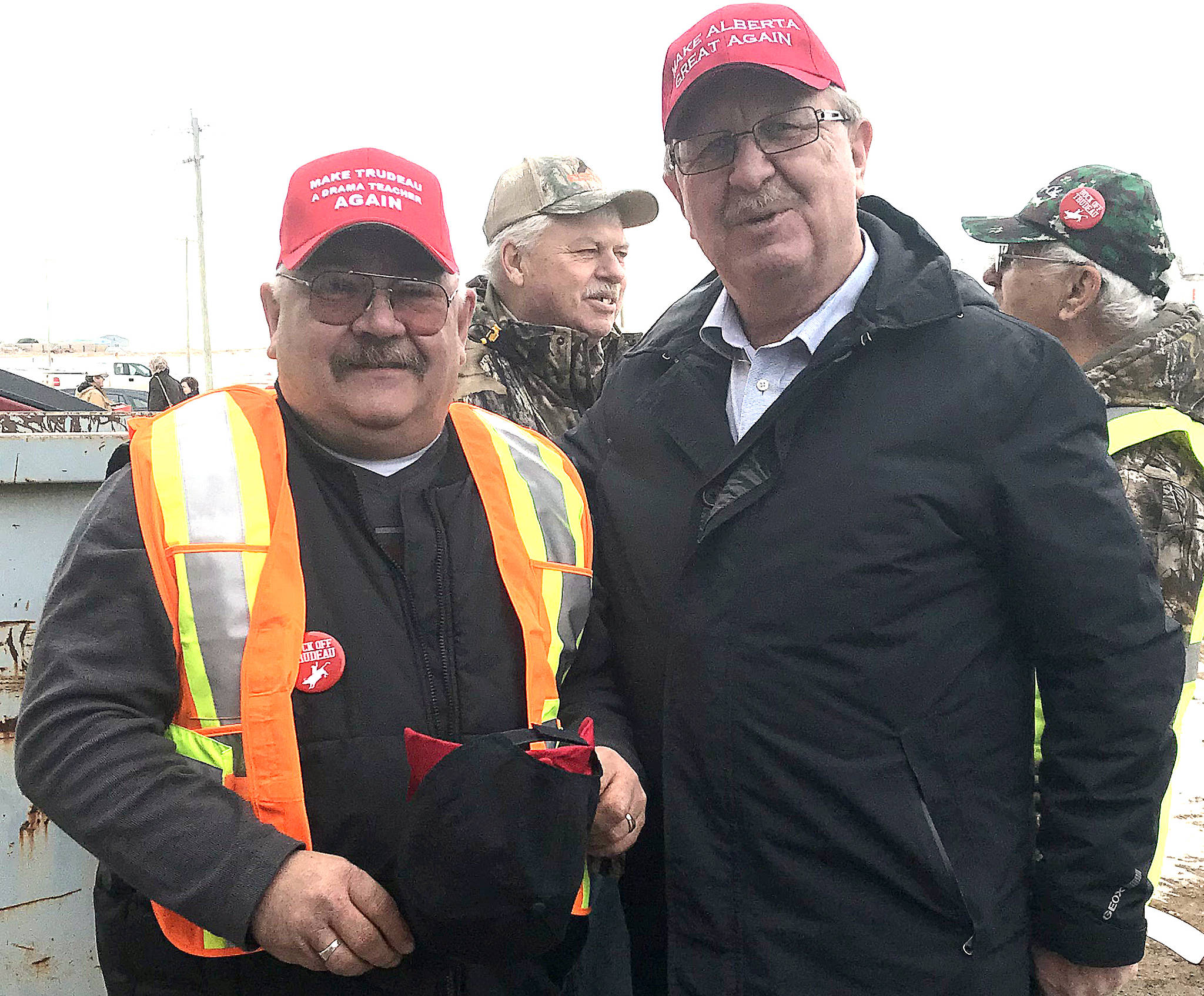 Greg Tschritter, event organizer, with MLA Rick Strankman wearing Make Alberta Great Again hats at the Stettler east Heartland Rally to support the oil and gas industry. (Lisa Joy/Stettler Independent)