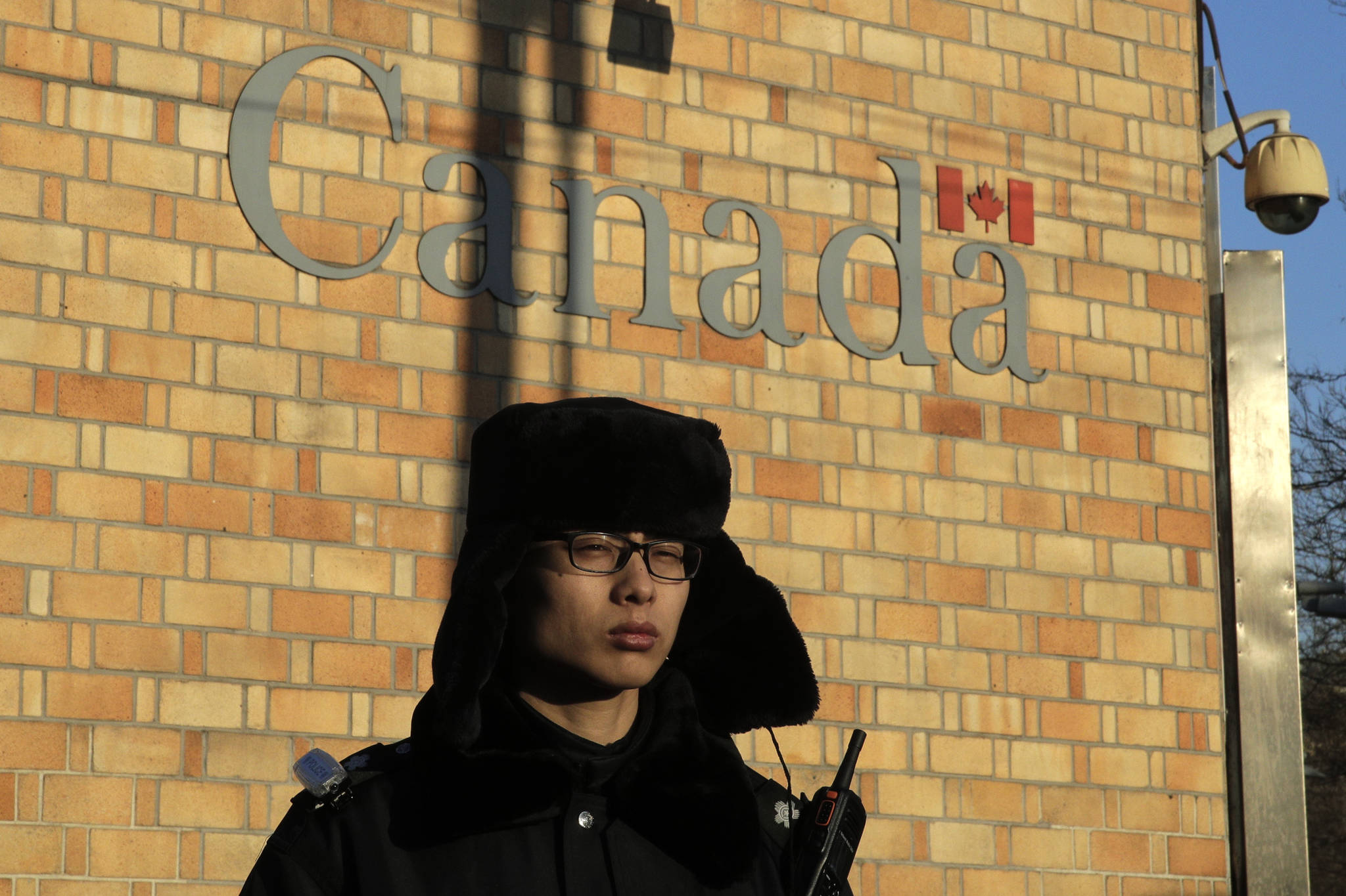 A policeman stands watch outside the Canadian Embassy in Beijing, Wednesday, Dec. 12, 2018. (AP Photo/Andy Wong)
