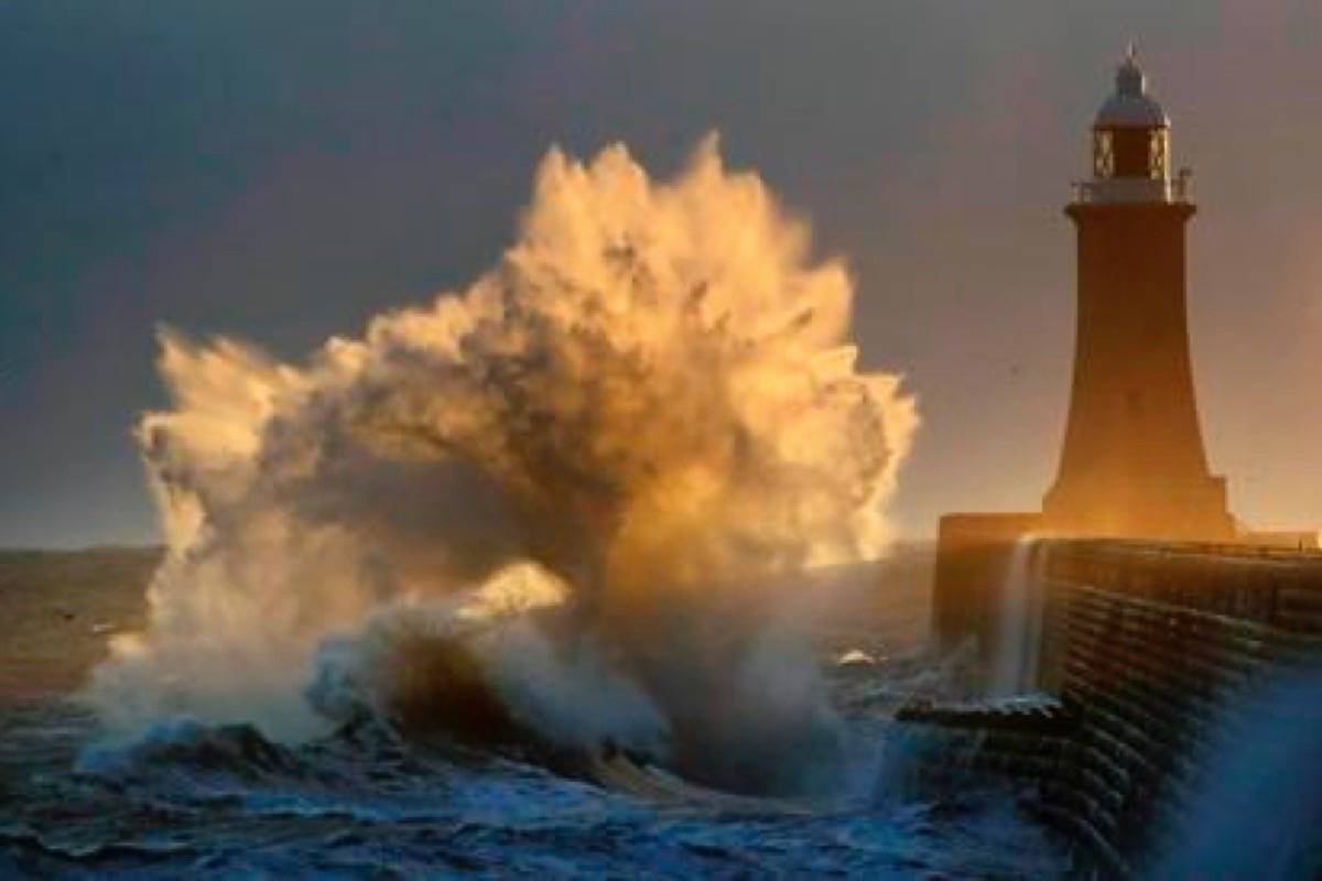 Waves batters the pier at Tynemouth on the north east coast of England, Sunday Jan. 27, 2019. (Owen Humphreys/PA via AP)