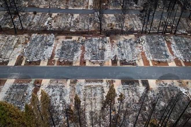 FILE- This Dec. 3, 2018, file photo shows homes leveled by the Camp Fire line the Ridgewood Mobile Home Park retirement community in Paradise, Calif. Insurance claims from California’s deadly November 2018 wildfires have topped $11.4 billion. (AP Photo/Noah Berger, File)