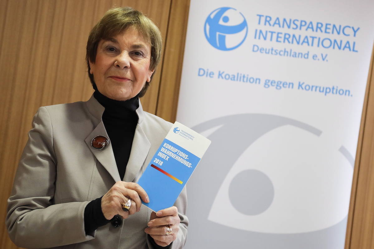 Edda Mueller, chairwoman of Transparency International Germany e.V. poses for the media with the Corruption Perceptions Index 2018, prior to the presentation of the yearly report at a news conference in Berlin, Germany, Tuesday, Jan. 29, 2019. The flyer reading: ‘Corruption Perceptions Index 2018’. (AP Photo/Markus Schreiber)