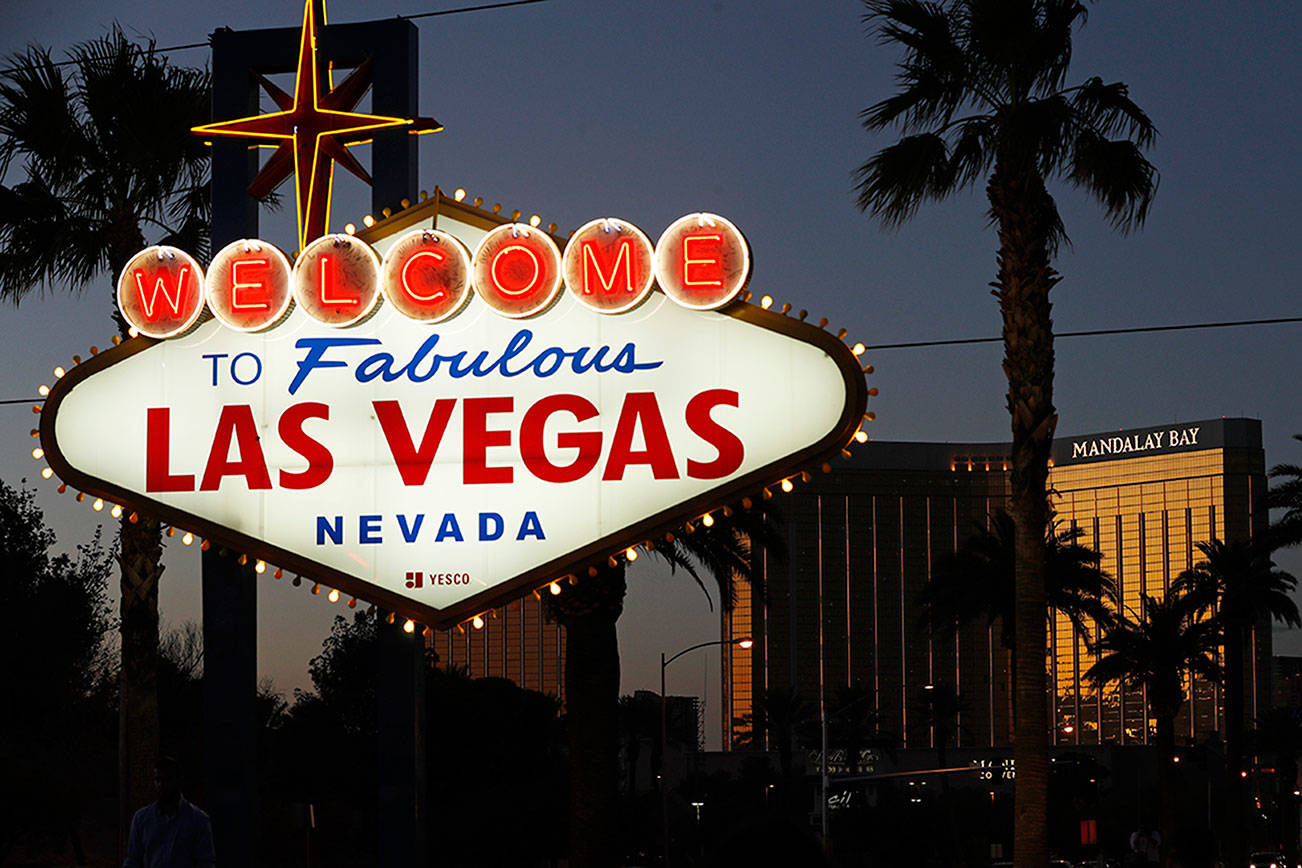 In this Sept. 21, 2018, photo, the Mandalay Bay hotel and casino reflects the last sunlight of the day along the Las Vegas Strip in Las Vegas. The hotel was the scene of the the worst mass shooting in modern U.S. history when a gunman killed 58 people at a country music festival in 2017. (AP Photo/John Locher)