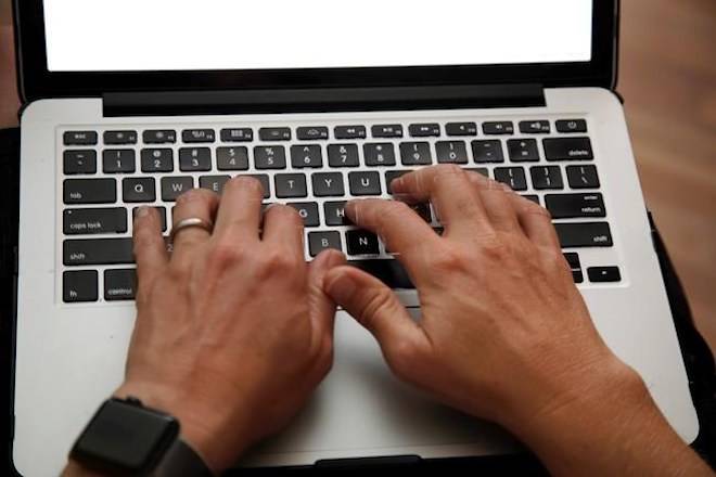 A person works on a laptop in North Andover, Mass., June 19, 2017 file photo. A leading cybersecurity analyst tells MPs that foreign hackers have targeted Canadian banks, mining companies and government institutions in recent years to steal valuable secrets and spread malware. THE CANADIAN PRESS/AP/Elise Amendola