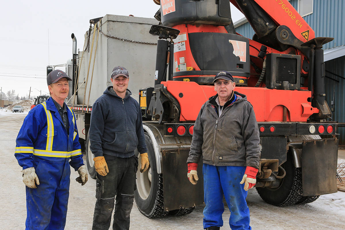 Dallas Bergstrom (centre), stands with longtime Bashaw Concrete staffers Norm and Carl, who are helping to train him in various aspects of the business.