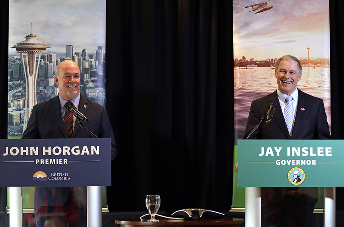 British Columbia Premier John Horgan, left, and Washington Gov. Jay Inslee listen to a question during a joint news conference Thursday, Feb. 7, 2019, in Seattle. The two met earlier in the day to discuss regional issues and opportunities for collaboration between B.C. and Washington state. Horgan will give a formal address to the Washington state Legislature on Friday. Inslee addressed the British Columbia legislature in Victoria during a visit November 2017. (AP Photo/Elaine Thompson)