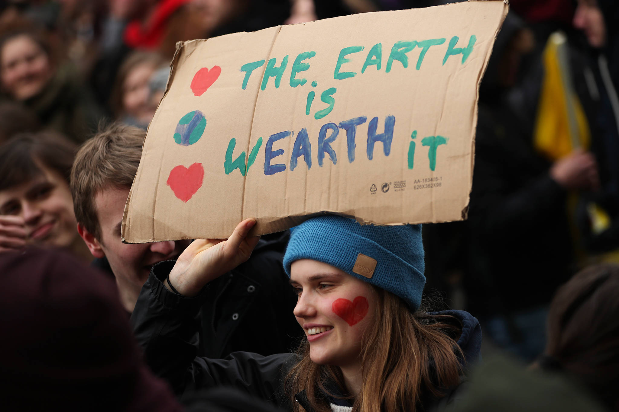 A young woman holds up a board as she marches with others during a climate change protest in Brussels, Thursday, Jan. 31, 2019. Thousands of teenagers in Belgium have skipped school for the fourth week in a row in an attempt to push authorities into providing better protection for the world’s climate. (AP Photo/Francisco Seco)