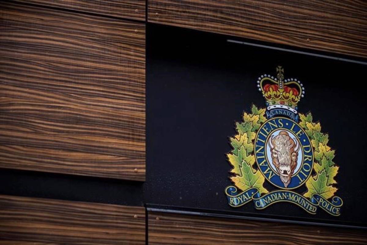 The RCMP logo is seen outside Royal Canadian Mounted Police “E” Division Headquarters, in Surrey, B.C., on Friday April 13, 2018. The RCMP say they’ve dismantled an international money laundering operation with a series of arrests in Quebec and Ontario today. (Darryl Dyck/The Canadian Press)