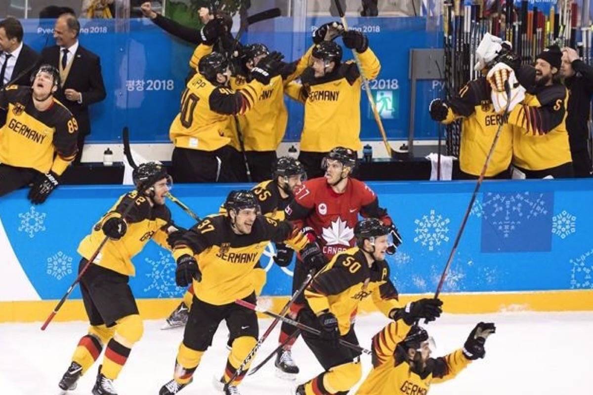 Canada defenceman Mat Robinson looks on as Germany players celebrate after defeating Canada to advance to the gold medal game during third period men’s semifinal Olympic hockey action at the 2018 Olympic Winter Games in Gangneung, South Korea on Friday, February 23, 2018. (THE CANADIAN PRESS/Nathan Denette)