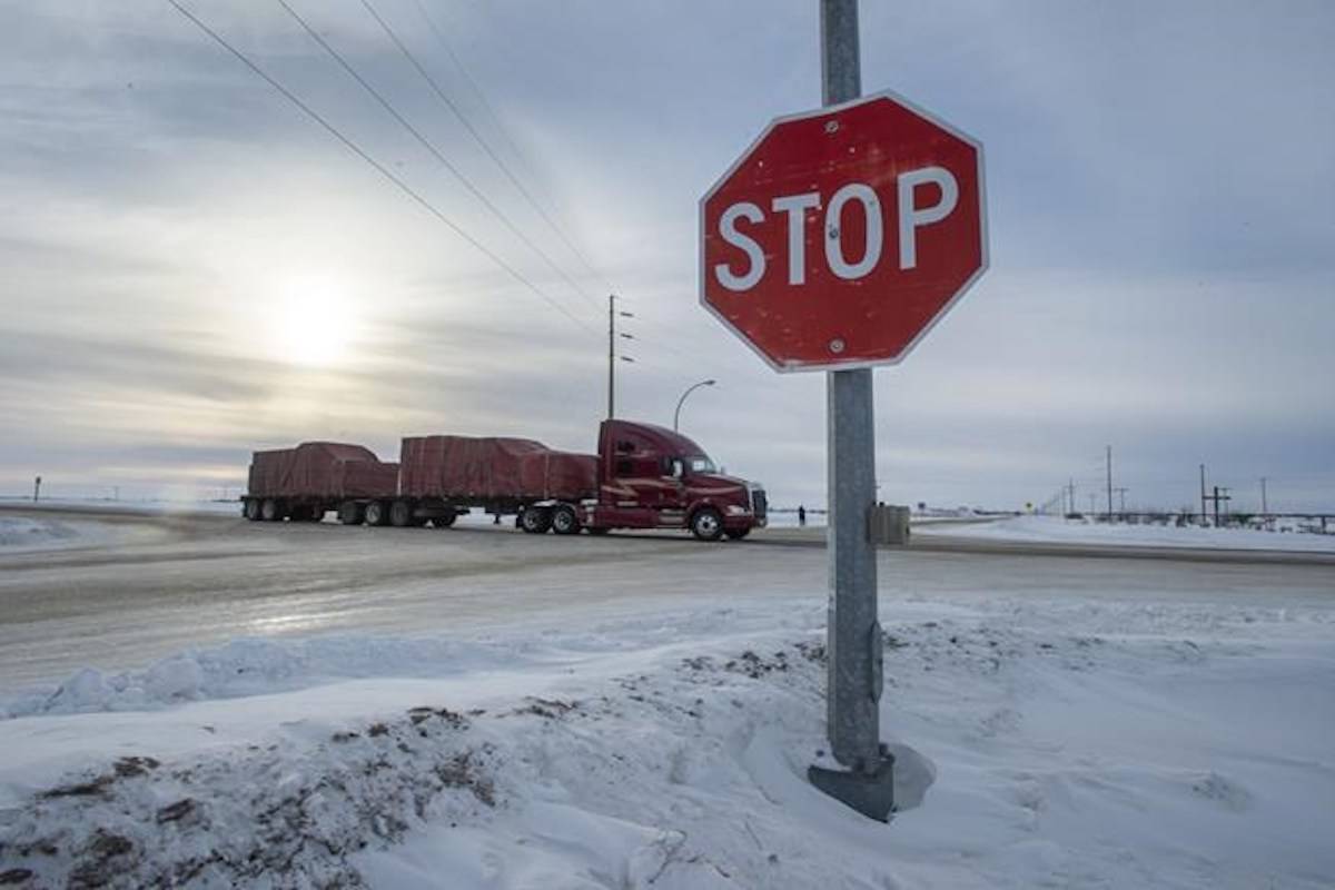 A truck goes through the intersection near the memorial for the 2018 crash where 16 people died and 13 injured when a truck collided with the Humboldt Broncos hockey team bus, at the crash site on Wednesday, January 30, 2019 in Tisdale, Sask. THE CANADIAN PRESS/Ryan Remiorz