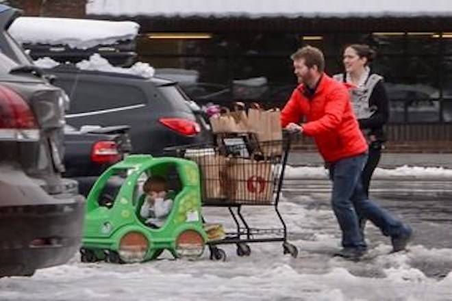 Jesse and Sarah Fees have their children along on a trip in North Tacoma, Wash., to restock their kitchen, Sunday, Feb. 10, 2019. (Peter Haley/The News Tribune via AP)