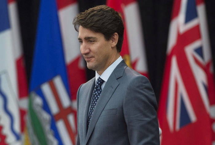 Canada Prime Minister Justin Trudeau makes his way to his seat at the start of the First Ministers Meeting in Ottawa, Tuesday, Oct. 3, 2017. (Adrian Wyld/The Canadian Press via AP)