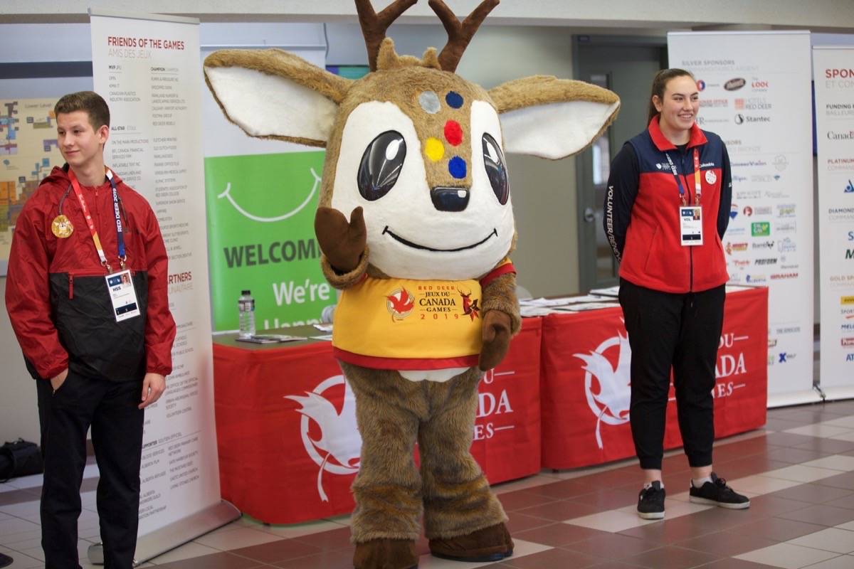 Waskasoo, the 2019 Canada Winter Games mascot, and some volunteers greet young athletes as they arrive on the campus of Red Deer College Thursday morning. Athletes from across Canada are arriving throughout the day today and tomorrow. Robin Grant/Red Deer College