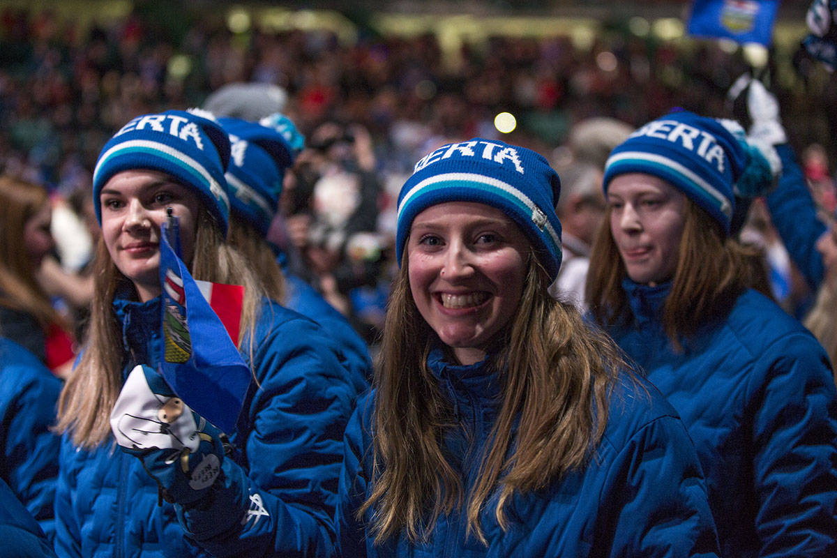 Athletes Torrie Shennan, left, Hannah Coyne, and Megan Riou with Team Alberta Ringette make their entrance during the Parade of Athletes at the Opening Ceremony Friday night. Robin Grant/Red Deer Express