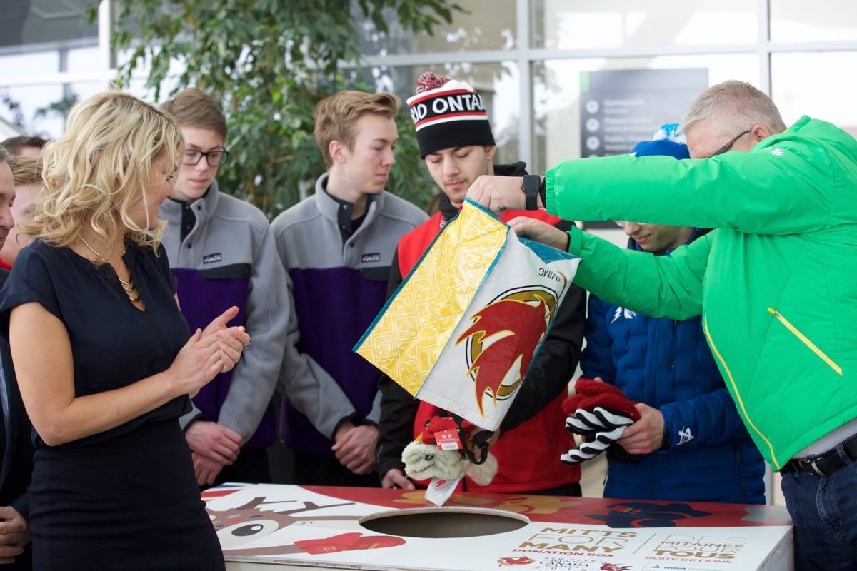 Mayor Tara Veer and Canada Winter Games athletes donate mittens to the Mitts for Many Program that launched Saturday morning at the Gary W. Harris Canada Games Centre. Robin Grant/Red Deer Express