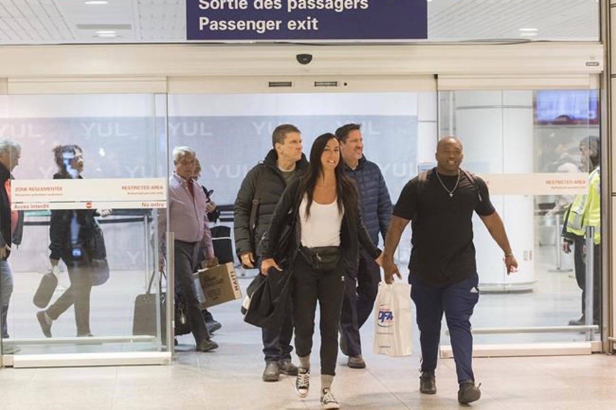 Passengers arrive at Trudeau airport in Montreal, Saturday, February 16, 2019. More than 100 Quebec tourists who had been trapped in Haiti amid violent street protests were flown back to Montreal on Saturday. (Graham Hughes/The Canadian Press)