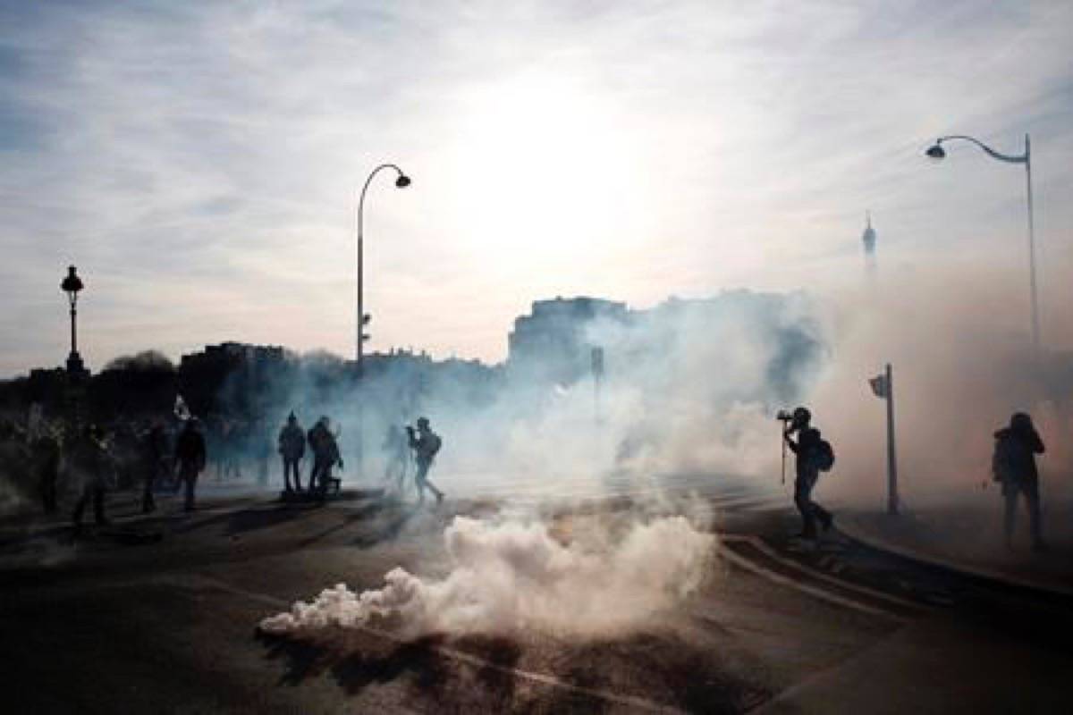Reporters follow demonstrators during scuffles with riot police officers Saturday, Feb.16, 2019 in Paris. Hundreds of yellow vest protesters marched through Paris, one of seven scattered demonstrations in the French capital Saturday, for the 14th straight weekend. (AP Photo/Thibault Camus)