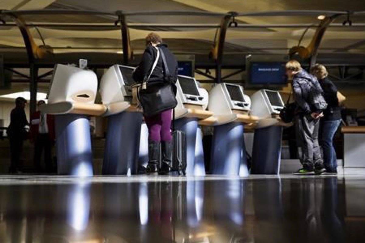 In this Jan. 30, 2017 file photo, passengers check in for Delta Air Lines flights at kiosks at Hartsfield-Jackson Atlanta International Airport in Atlanta.Canada’s largest airlines are awaiting details from the federal government before they follow their U.S. counterparts in allowing travellers to choose gender designations outside the traditional “male” and “female” check-in categories. (THE CANADIAN PRESS/AP/David Goldman, File)