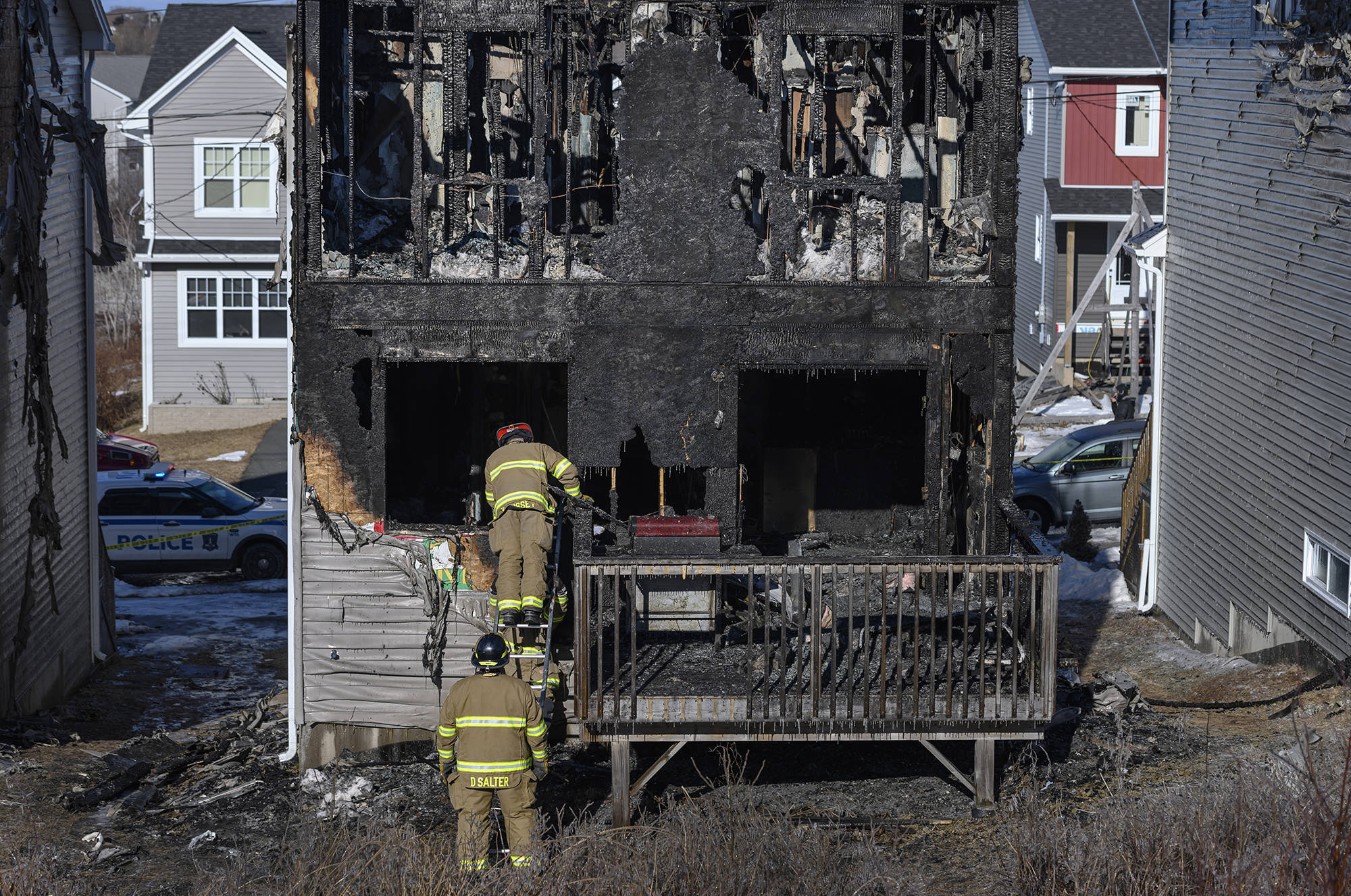 Firefighters investigate following a house fire in the Spryfield community in Halifax on Tuesday, February 19, 2019. Halifax police say they have responded to a fatal fire in the city, although there are no details on how many people are victims. Police say firefighters were called to a home on Quartz Drive in Spryfield around 1 a.m. today. (Darren Calabrese/The Canadian Press)