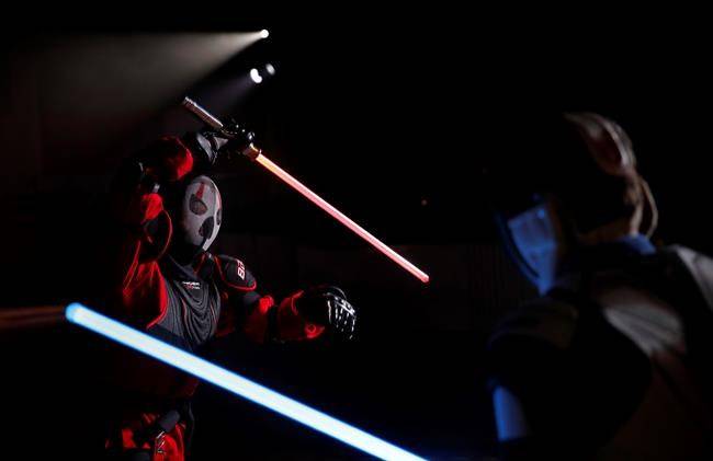 Julien Esprit, left, competes with Jean Baptiste Marchetti-Waternaux during the national lightsabers tournament in Beaumont-sur-Oise, north of Paris. (AP Photo/Christophe Ena)