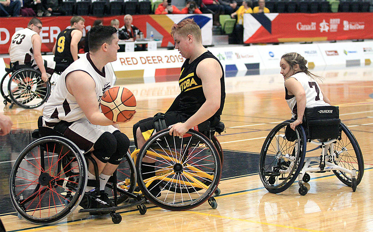 Newfoundland and Labrador’s Danielle Arbour looks to set a screen on Manitobas Josh Brown in order to allow her teammate Nick Power to head up the floor in this consolation round wheelchair basketball match Feb. 20th at the G.W. Harris Canada Games Centre. Photo by Jordie Dwyer