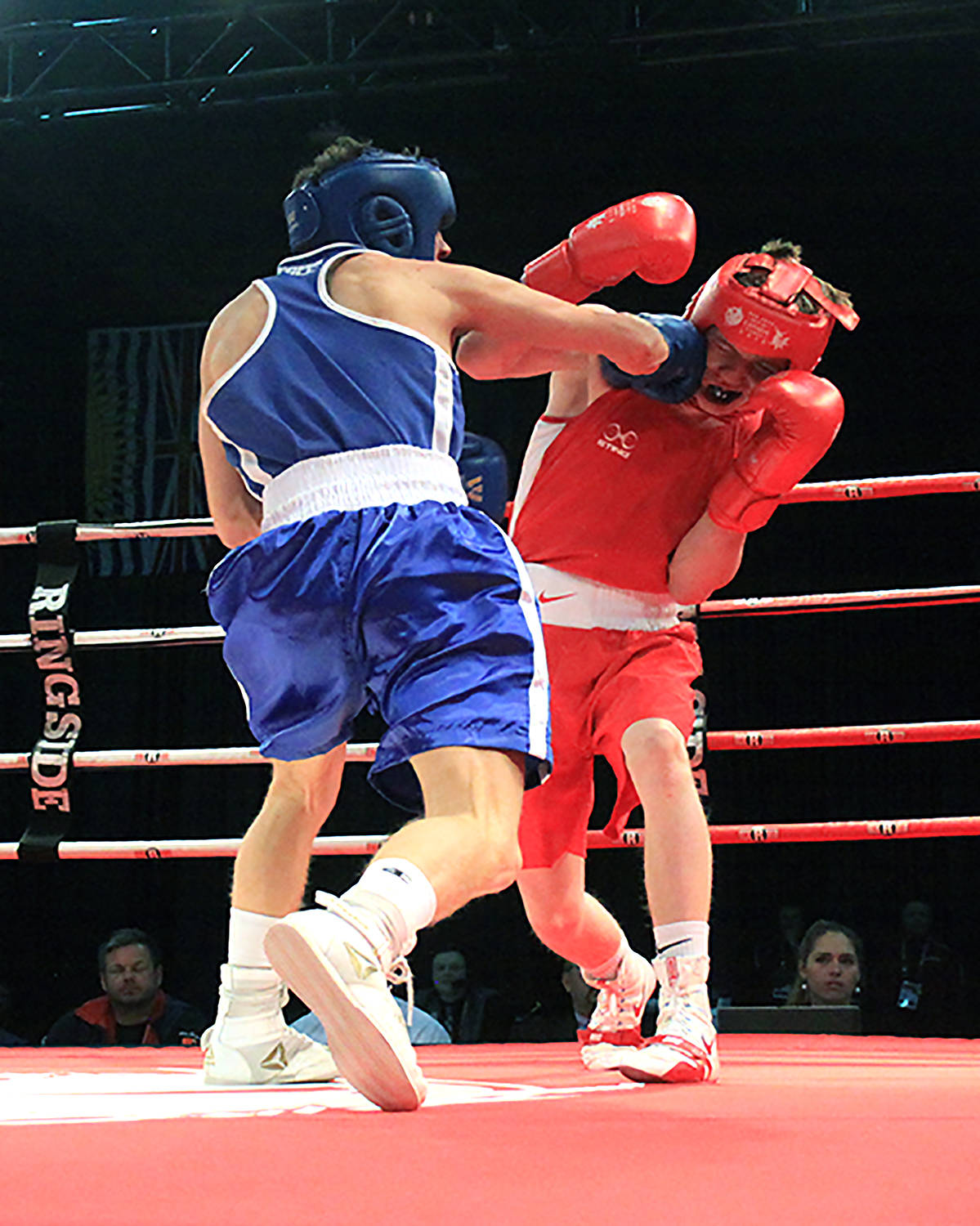 Kyle Oliver from Alberta, in red, takes a good shot from his Ontario opponent Christopher Lucas Craston during the second round of the 60kg bronze medal match, won by Craston on points, on Feb. 20th at Westerner Park. Photos by Jordie Dwyer