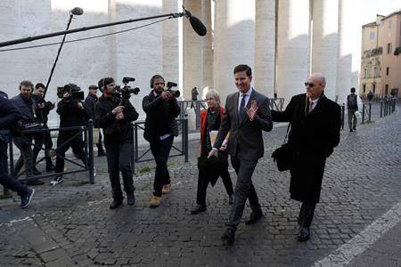 Juan Carlos Cruz, second from right, waves to journalists as walks to meet with organizers of the summit on preventing sexual abuse at the Vatican, Wednesday, Feb. 20, 2019. (AP Photo/Gregorio Borgia)